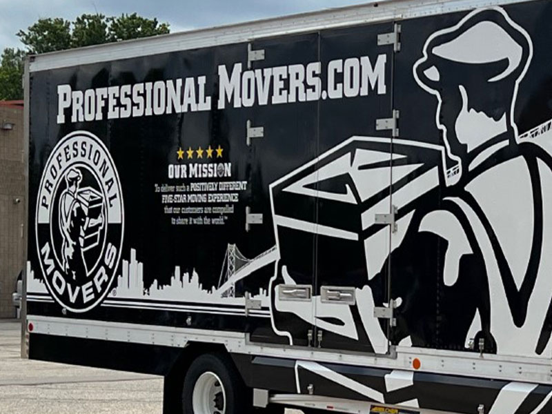 A moving truck with "Professional Movers.com" branding and a graphic of a mover carrying a box on the side.